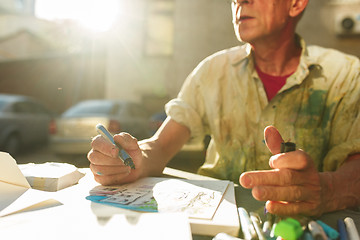 Image showing Close up man working of Architect sketching a construction project on his plane project at site construction work