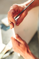 Image showing Close up man working of Architect sketching a construction project on his plane project at site construction work