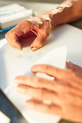 Image showing Close up man working of Architect sketching a construction project on his plane project at site construction work