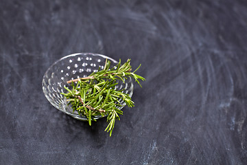 Image showing Fresh rosemary herb in glass bowl.