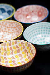 Image showing Five colorful empty ceramic bowls.