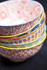 Image showing Stack of colorful empty ceramic bowls closeup.