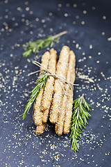 Image showing Italian grissini or salted bread sticks with sesame and rosemary