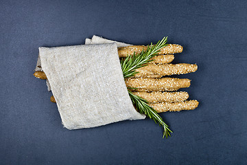 Image showing Italian grissini or salted bread sticks with sesame and rosemary