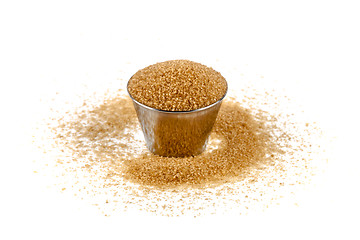 Image showing Brown cane sugar in metal bowl isolated on white background.