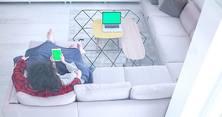 Image showing couple relaxing at  home with tablet computers