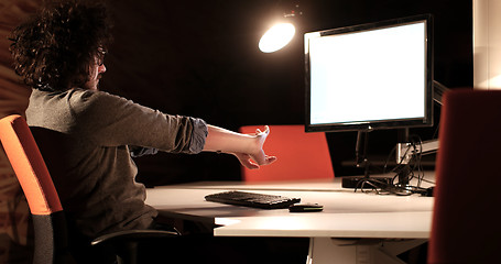 Image showing man working on computer in dark office