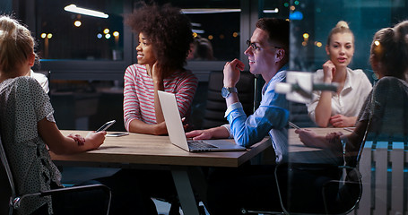 Image showing Multiethnic startup business team in night office