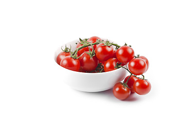 Image showing Fresh organic cherry tomatoes bunch on ceramic bowl.