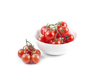 Image showing Fresh organic cherry tomatoes bunch on ceramic bowl.