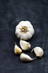 Image showing Fresh raw organic garlic on black board.