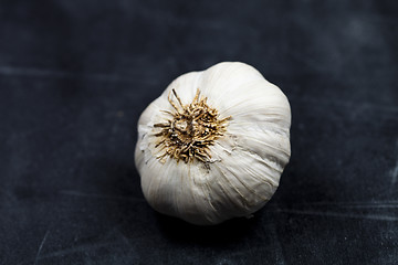 Image showing Fresh raw organic garlic on black board.