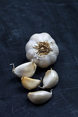 Image showing Fresh raw organic garlic on black board.