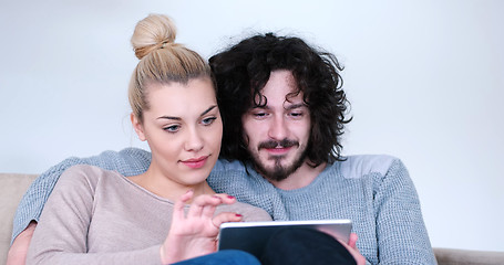 Image showing couple relaxing at  home with tablet computers