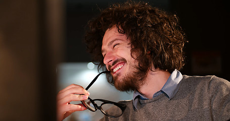 Image showing man working on computer in dark office