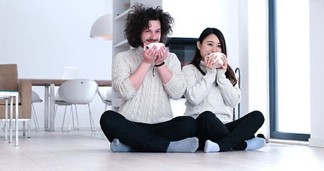 Image showing multiethnic romantic couple  in front of fireplace