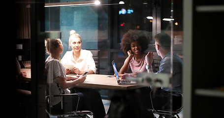 Image showing Multiethnic startup business team in night office