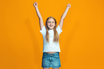 Image showing Happy success teen girl celebrating being a winner. Dynamic energetic image of female model