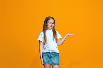 Image showing Happy success teen girl presenting something