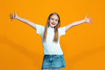 Image showing Happy success teen girl celebrating being a winner. Dynamic energetic image of female model