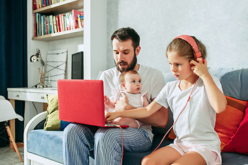 Image showing father and his daughters at home