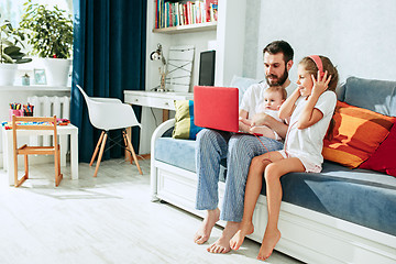 Image showing father and his daughters at home