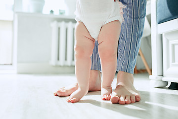 Image showing father and his baby daughter at home