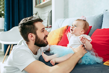 Image showing Proud father holding his baby daughter at home