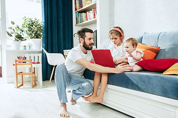 Image showing father and his daughters at home