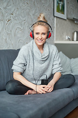 Image showing Portrait of attractive woman using smart phone to listen to music