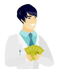 Image showing Young asian doctor holding money.