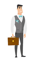 Image showing Caucasian groom holding briefcase.