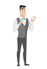 Image showing Caucasian groom holding a mobile phone.