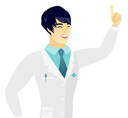 Image showing Young asian doctor pointing with his forefinger.