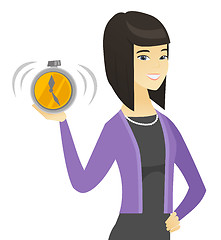 Image showing Asian business woman holding alarm clock.