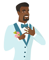 Image showing Cheerful groom showing golden ring on his finger.