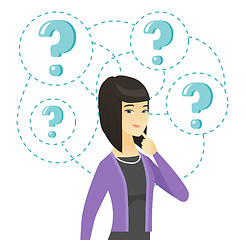 Image showing Young business woman standing under question marks