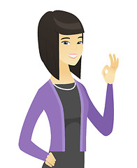 Image showing Smiling asian business woman showing ok sign.
