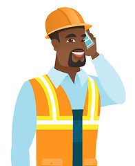 Image showing African-american builder talking on mobile phone.
