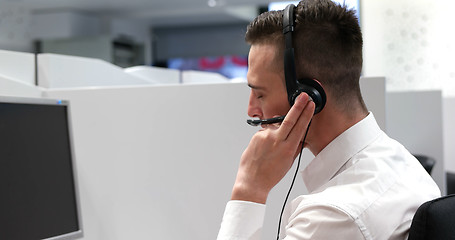 Image showing male call centre operator doing his job