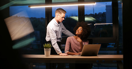 Image showing Multiethnic startup business team in night office