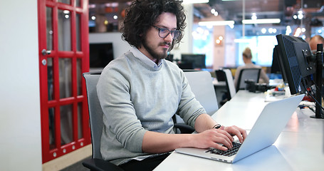 Image showing businessman working using a laptop in startup office