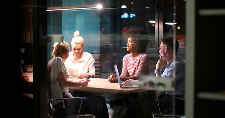 Image showing Multiethnic startup business team in night office