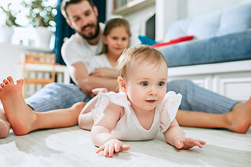 Image showing Proud father holding his newborn baby daughter at home