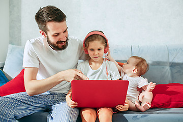 Image showing father and his daughters at home