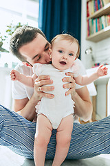 Image showing father and his baby daughter at home