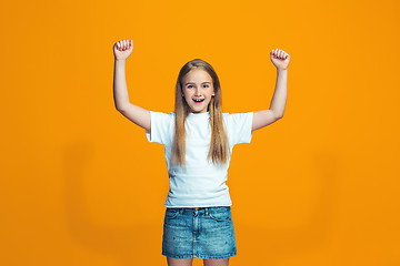 Image showing Happy success teen girl celebrating being a winner. Dynamic energetic image of female model