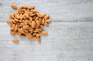 Image showing Almonds scattered over white stone board