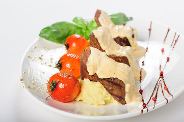 Image showing Baked mutton meat with creamy sauce, mashed potato and cherry tomatoes