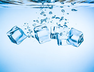 Image showing Ice cubes falling under water